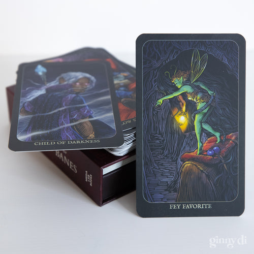 Game Master's Deck of Boons and Banes - Deck of rectangular cards with dark, fantasy-themed artwork featuring a glowing fairy holding a lantern on the front card.