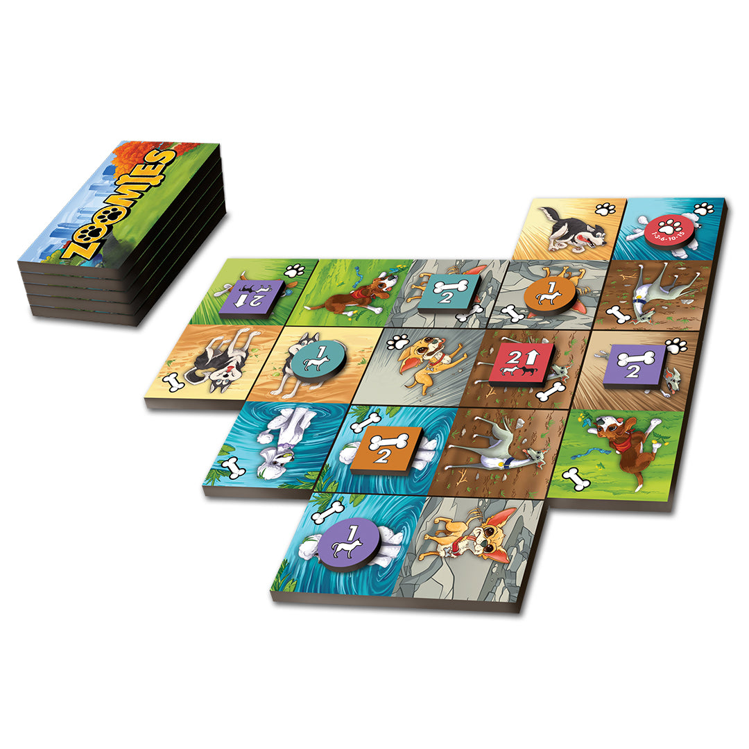 Zoomies - Colorful square tiles featuring cartoon dogs, bones, and numbered paw prints arranged in a grid with a stack of cards nearby.