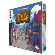 Tiny Towns - Colorful game box with illustrated medieval-style village featuring cobblestone streets and whimsical buildings.