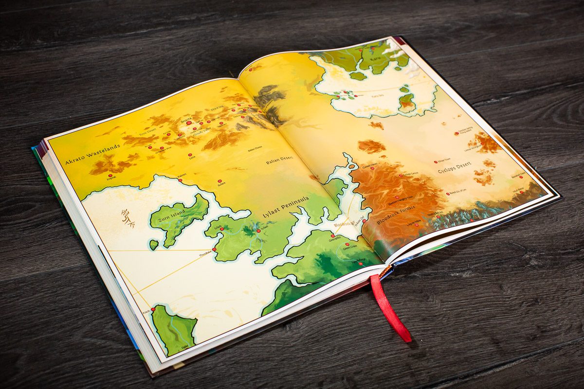 World of Arzium RPG - Open RPG book with colorful fantasy world maps showing islands and terrain in green, yellow, and orange tones.