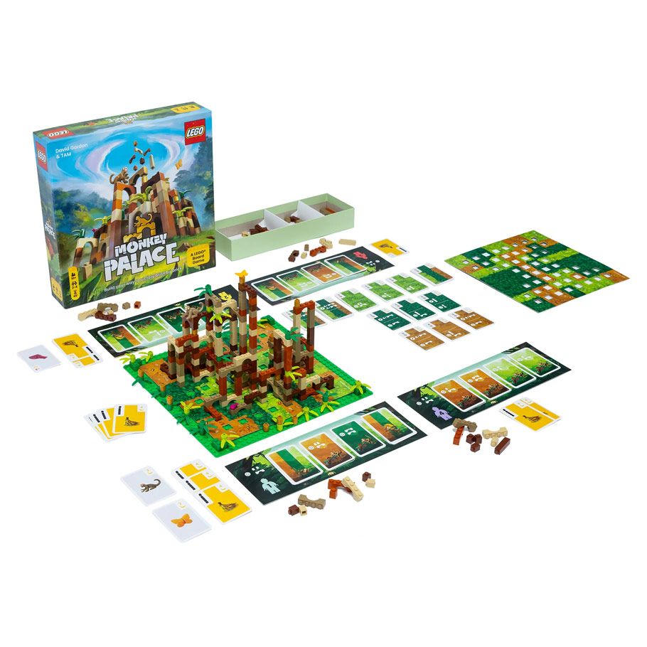 Monkey Palace - Colorful board game set featuring a jungle-themed 3D monkey palace with cards, tokens, and player boards arranged on a green