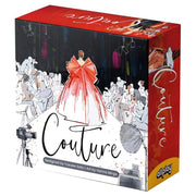 Couture - Card game box featuring fashion illustration of a red couture gown on runway with audience and studio lights.