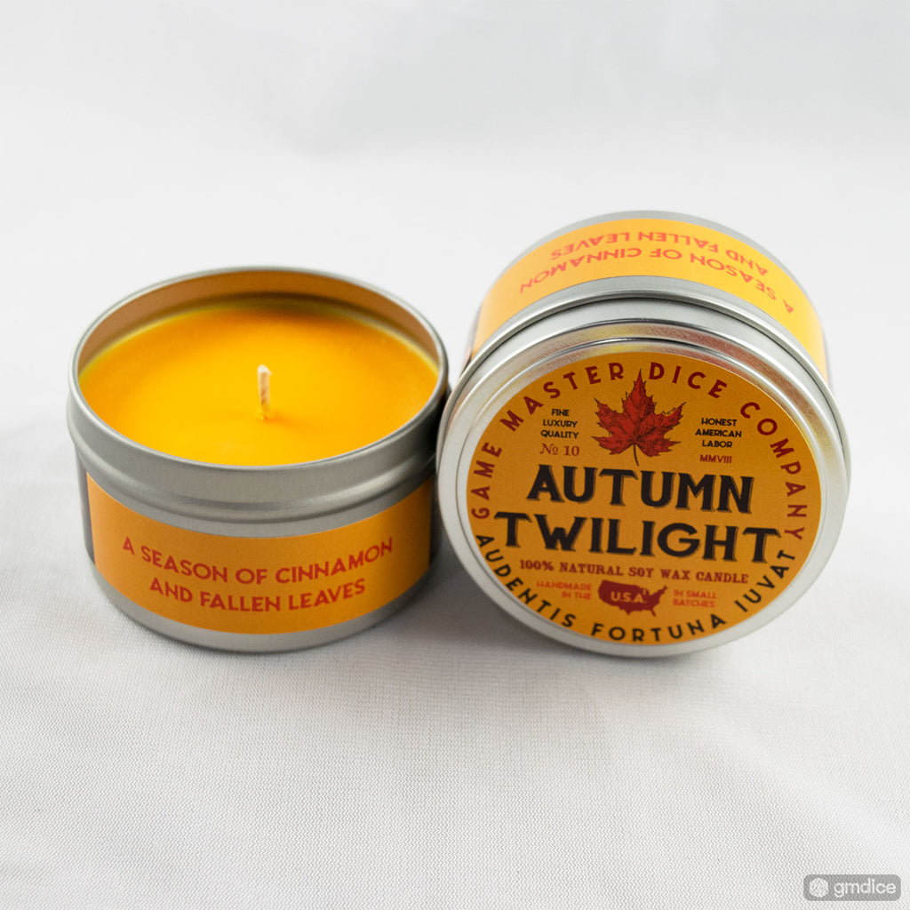 Autumn Twilight Gaming Candle - Round metal tin candle with bright orange wax and autumn-themed label featuring a brown leaf and orange text.