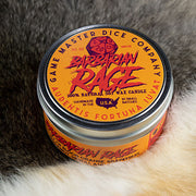 Barbarian Rage Gaming Candle - Round metal tin candle labeled Barbarian Rage with orange and yellow colors and red text on lid and side.