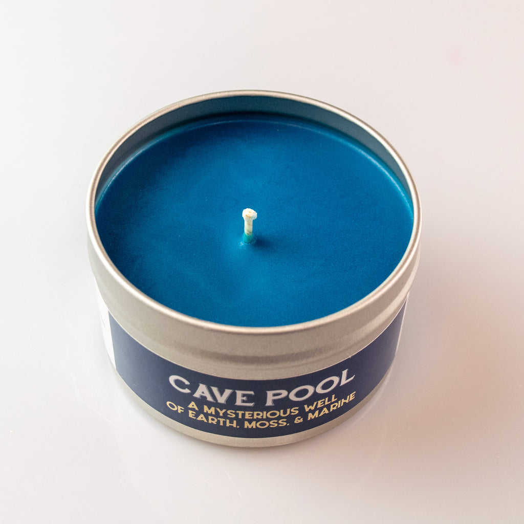Cave Pool Gaming Candle - Blue wax candle in a round silver tin labeled Cave Pool with earthy moss scent.