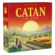 CATAN – The Game (6th Edition) - Square board game box with a red and orange gradient background, featuring a large yellow sun setting over a scenic rural.