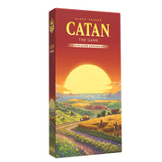 CATAN – 5-6 Player Expansion (6th Edition) - Tall rectangular box with a sunset landscape featuring fields, hills, and a winding dirt road, labeled "CATAN – 5-6 Player.