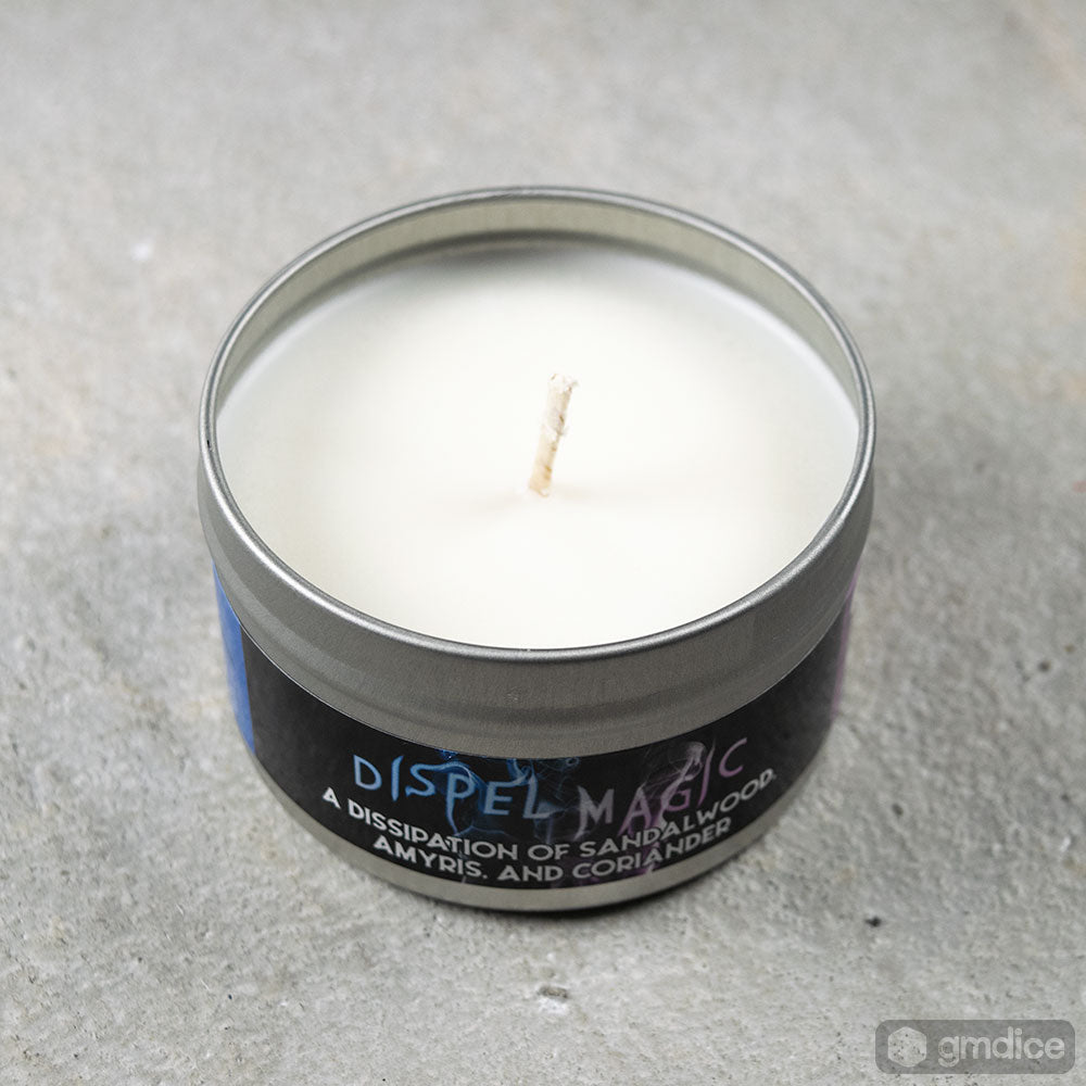 Dispel Magic Gaming Candle - Small round metal tin candle with white wax and label reading "Dispel Magic" in blue and purple font.