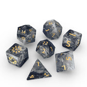Cosmere RPG: Mistborn Basic Dice Set (PREORDER) - Seven dark gray marbled polyhedral dice with gold numbers, including d20, d12, d10, d8, d6, d4, and percentile die.