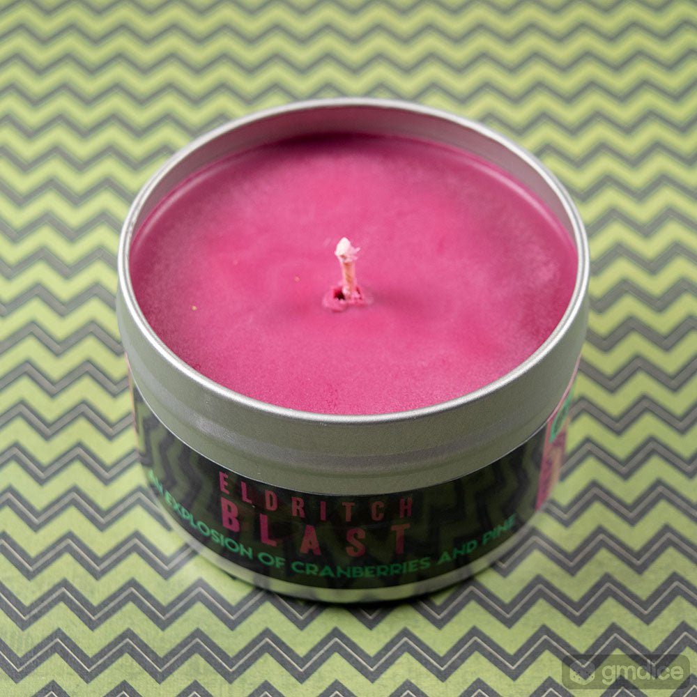 Eldritch Blast Gaming Candle - Small round tin candle with deep magenta wax and black label displaying vivid green and red text on a zigzag green.