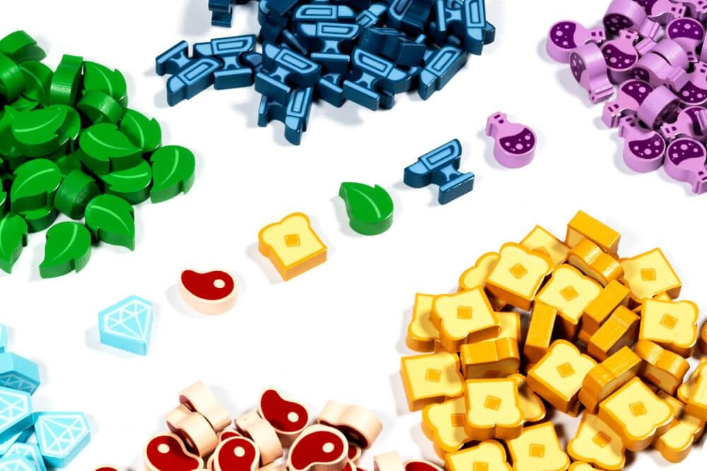 Flamecraft: Wooden Resources (2nd Edition) (PREORDER) - Assorted small wooden game tokens in green, blue, purple, yellow, red, and light blue representing resources for a board.