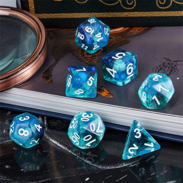 Jellyfish Dice Set - Seven translucent blue polyhedral dice with white numbers, featuring a swirling jellyfish-like pattern inside.