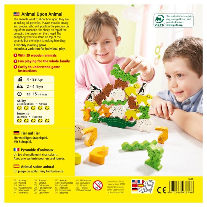 Animal Upon Animal - Brightly colored wooden animal stacking game with various animal shapes balanced on a green base, played by two children.