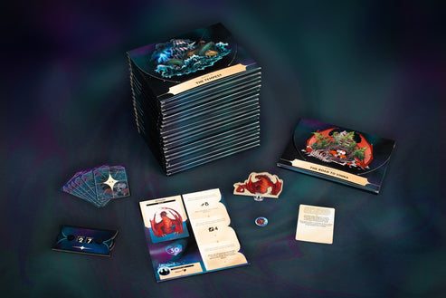 Kinfire Chronicles: Night's Fall 2nd Printing - Night's Fall 2nd Printing game boxes with colorful fantasy art, playing cards, tokens, and rulebook displayed on dark.