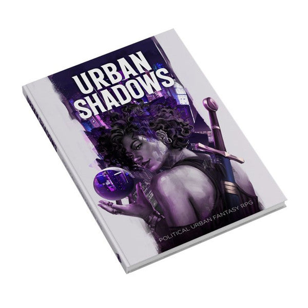 Urban Shadows 2E: Core Book - Softcover book with dark purple and black cover art featuring a mysterious woman holding a glowing orb, titled Urban Shadows