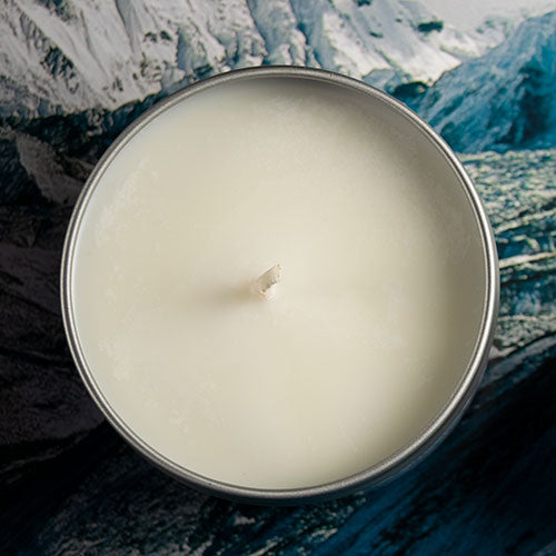Mountain Monastery Gaming Candle - Round white wax candle in a silver metal tin with a centered wick, smooth surface.