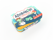 Adorablins - Small rectangular tin box with rounded edges in bright teal and yellow, featuring cartoon animal illustrations and bold.
