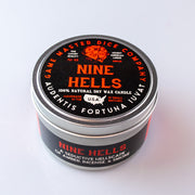 Nine Hells Gaming Candle - Black round tin candle with red and white text, labeled Nine Hells by Game Master Dice Company.