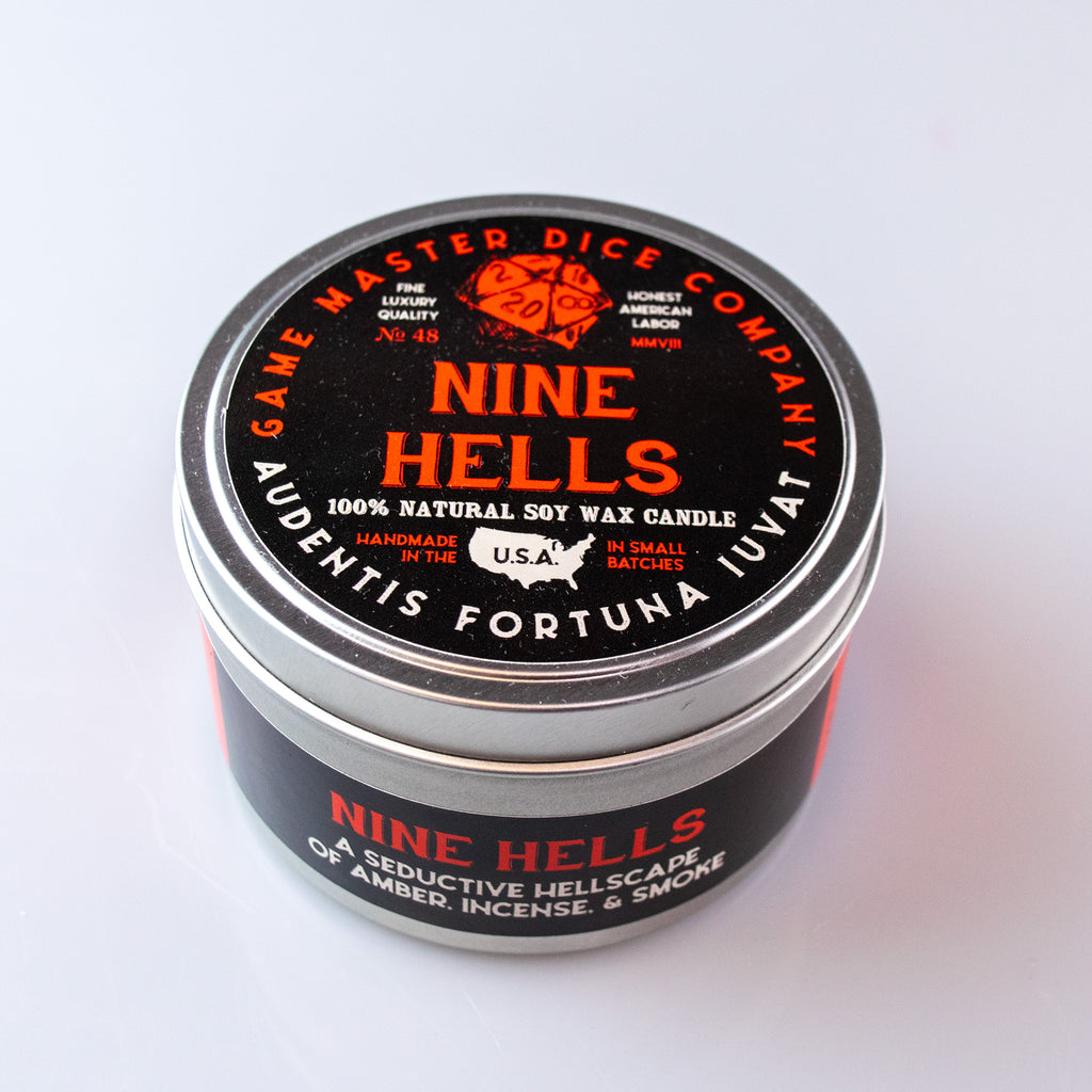 Nine Hells Gaming Candle - Black round tin candle with red and white text, labeled Nine Hells by Game Master Dice Company.