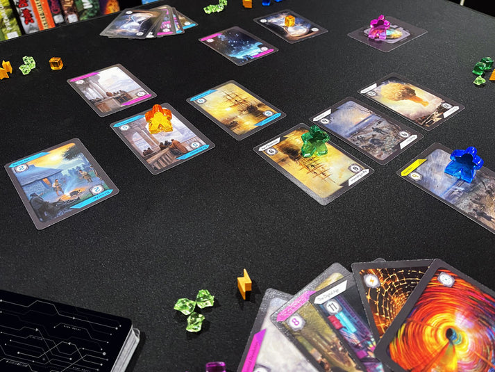 Time Splicers (PREORDER) - Card game setup with illustrated cards featuring sci-fi and fantasy themes, colorful translucent game tokens on a black.