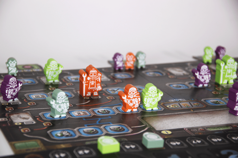 Phoenix New Horizon - Colorful translucent game figures in green, orange, purple, and white arranged on a detailed strategy game board with.