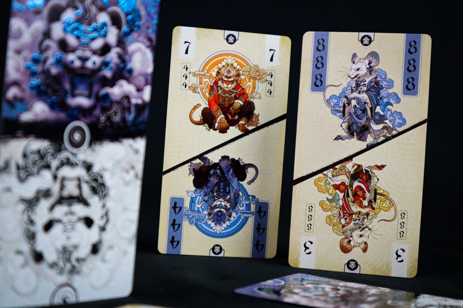 Panda Spin (PREORDER) - Playing cards featuring intricate, colorful illustrations of mythical characters on a cream background with black dividing.
