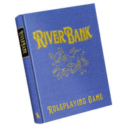 Riverbank RPG Limited Edition - Blue hardcover book with gold embossed title "Riverbank" and illustration of river rocks and leaves, labeled "Roleplaying.