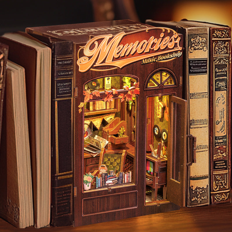 Memories Music Bookshop Nook (PREORDER) - Miniature vintage-style bookshop nook with warm yellow lighting, detailed shelves, and wooden textures inside a brown.