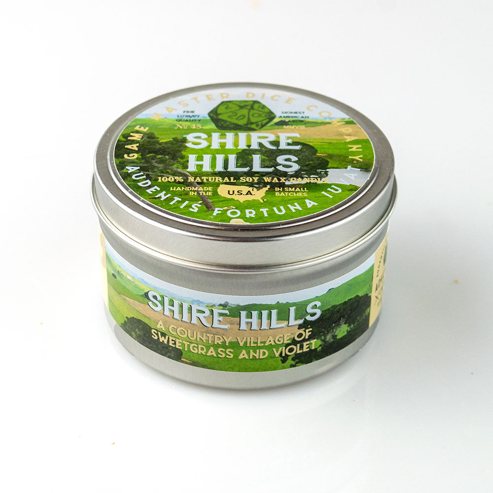 Shire Hills Candle - Small glass candle jar with silver screw lid, green label featuring a nature landscape and text "Shire Hills," scented with.