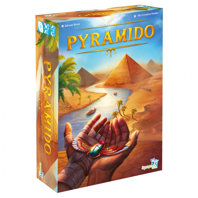 Pyramido - Brightly colored board game box featuring a desert scene with pyramids, palms, and a hand holding a jewel.