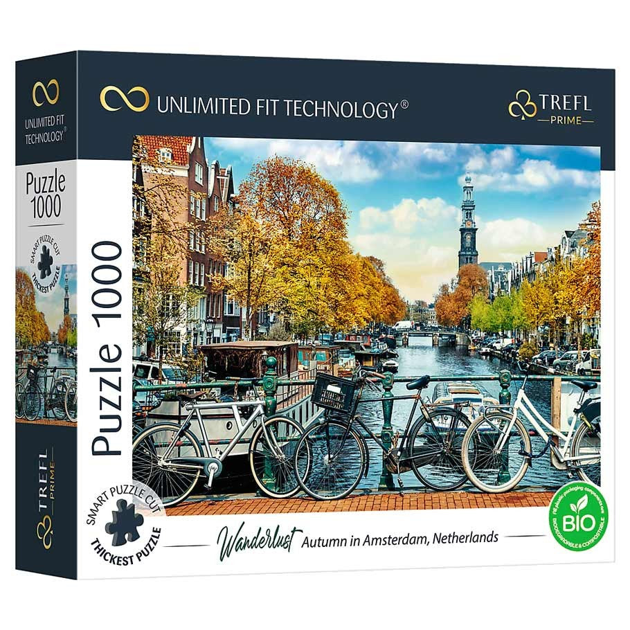 Wanderlust - Autumn in Amsterdam 1000 Piece Puzzle - 1000-piece puzzle box featuring an autumn canal scene in Amsterdam with bikes, colorful trees, and historic buildings.