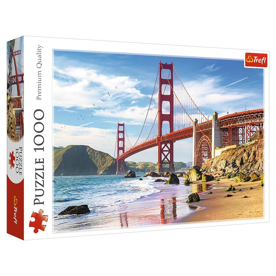 Golden Gate Bridge 1000 Piece Puzzle - 1000-piece puzzle box featuring the Golden Gate Bridge in red against a blue sky and sandy beach scene.