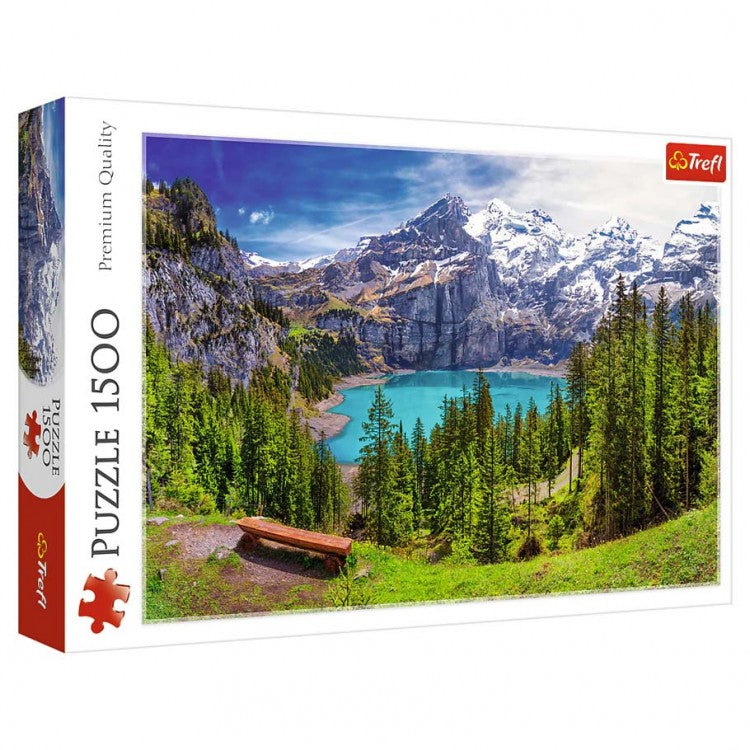 Puzzle: Lake Oeschinen, Alps 1500pc - 1500-piece puzzle featuring vibrant alpine lake with turquoise water, pine trees, and snow-capped mountains.