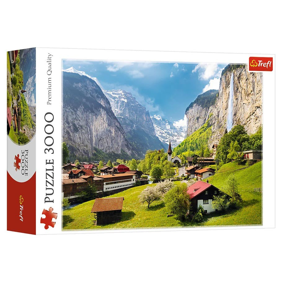 Lauterbrunnen Switzerland 3000 Piece Puzzle - 3000-piece puzzle box featuring a vibrant Lauterbrunnen valley with green fields, rustic houses, and towering cliffs under a