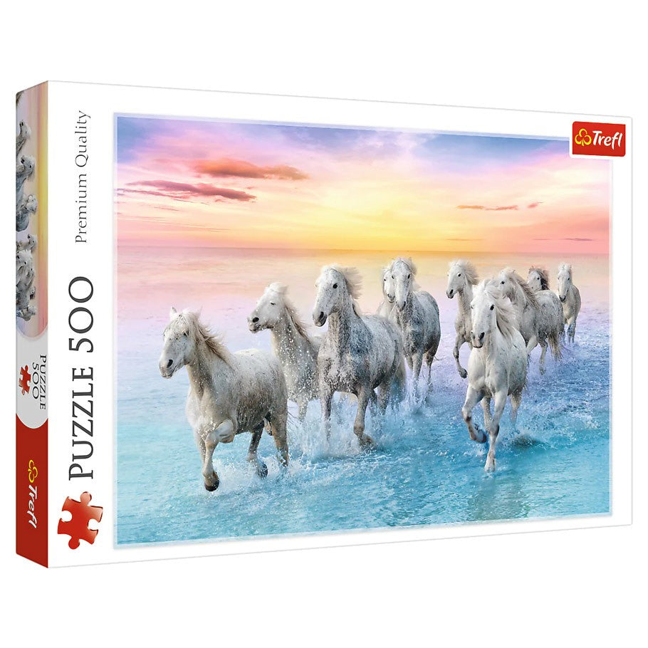 Galloping White Horses 500 Piece Puzzle - 500-piece puzzle box featuring white horses galloping through shallow water at sunset with a colorful sky background.