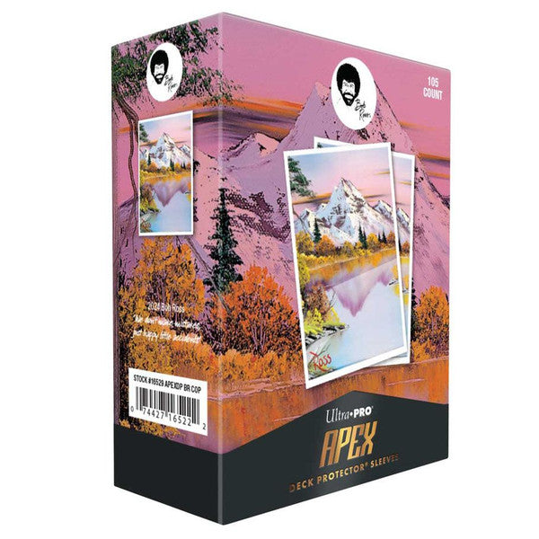 Deck Protector: Apex: Bob Ross: Mighty Mountain Lake - Rectangular deck protector box featuring Bob Ross-themed mountain landscape art with pink and orange hues, pine trees, and a