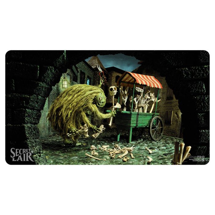 Playmat: Magic the Gathering: Secret Lair: Diabolical Dioramas: Fiend Artisan - Fantasy-themed gaming playmat featuring a mossy fiend pushing a cart of skeletons under a stone archway with muted green and