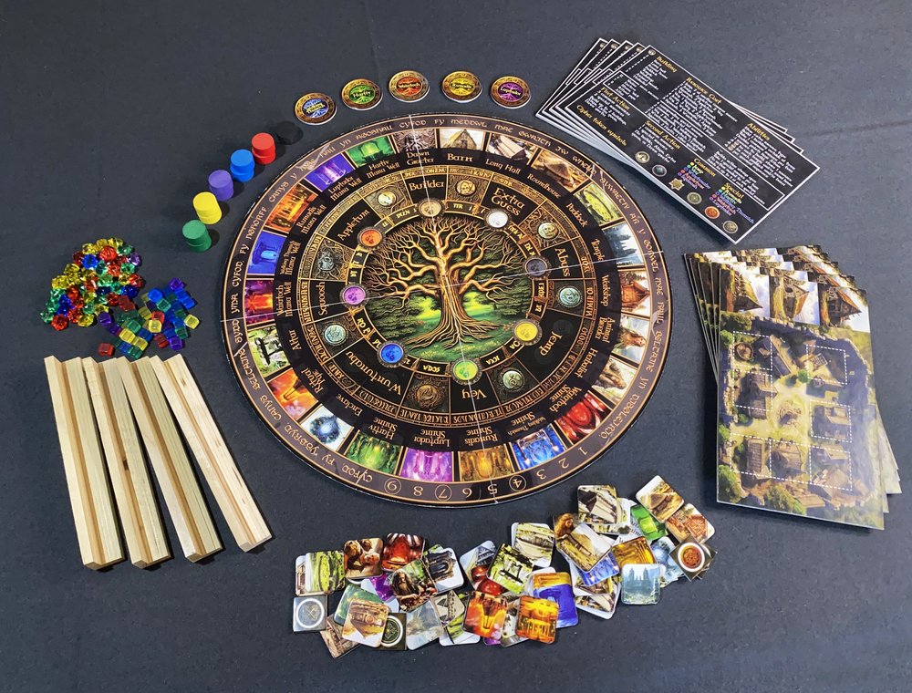 Sacred Cipher - Circular board game with intricate tree design at center, colorful tokens, wooden sticks, cards, and rule sheet laid out on.