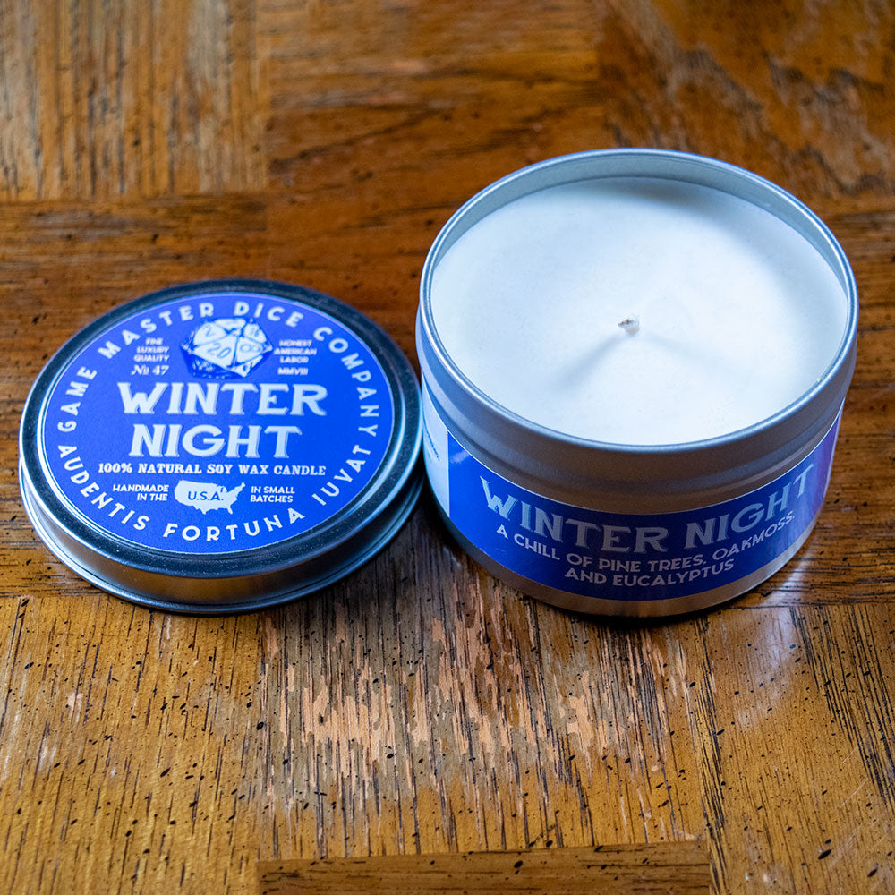Winter Night Gaming Candle - Blue metal tin candle with white wax labeled "Winter Night" and gaming-themed text on lid and side.