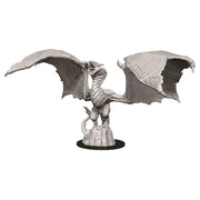 D&D Nolzur's Marvelous Miniatures: Wyvern - Gray unpainted plastic wyvern miniature with large outstretched wings standing on rocky base.
