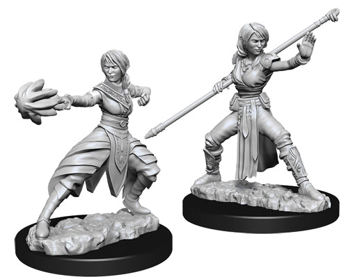 D&D Nolzur's Marvelous Miniatures: Female Half-Elf Monk - Two gray plastic fantasy miniatures of a female half-elf monk, one casting a spell with an open hand and the other wielding.