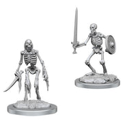Wizkids Deep Cuts Miniatures: Skeletons - Two gray plastic skeleton miniatures, one wielding dual curved swords, the other holding a sword and round shield, on.