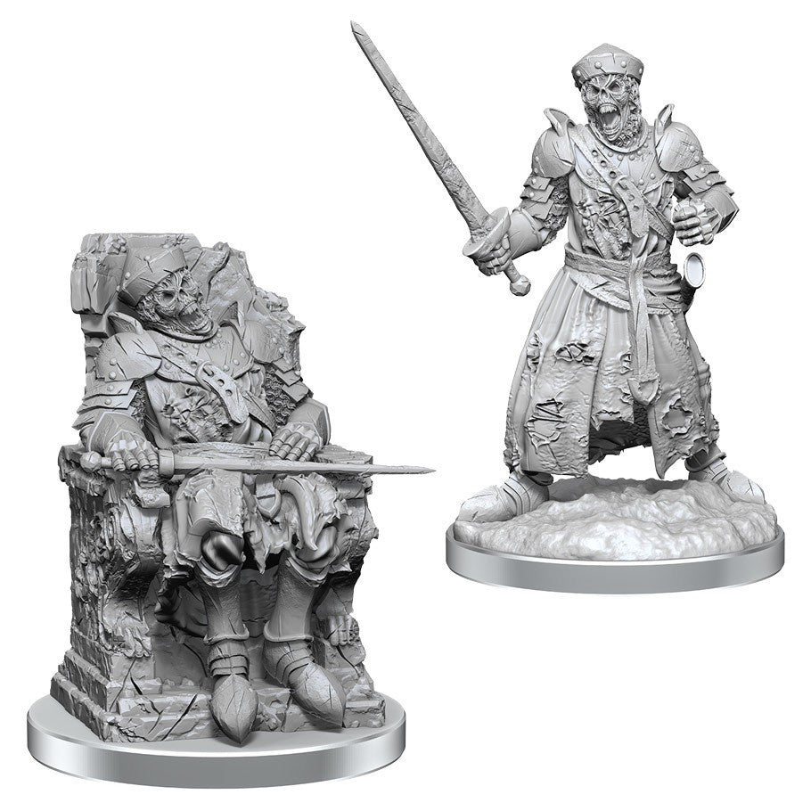 Deep Cuts: Dead Warlord - Two unpainted fantasy miniatures, one a wounded warrior on a throne with armor and sword, the other a standing armored.