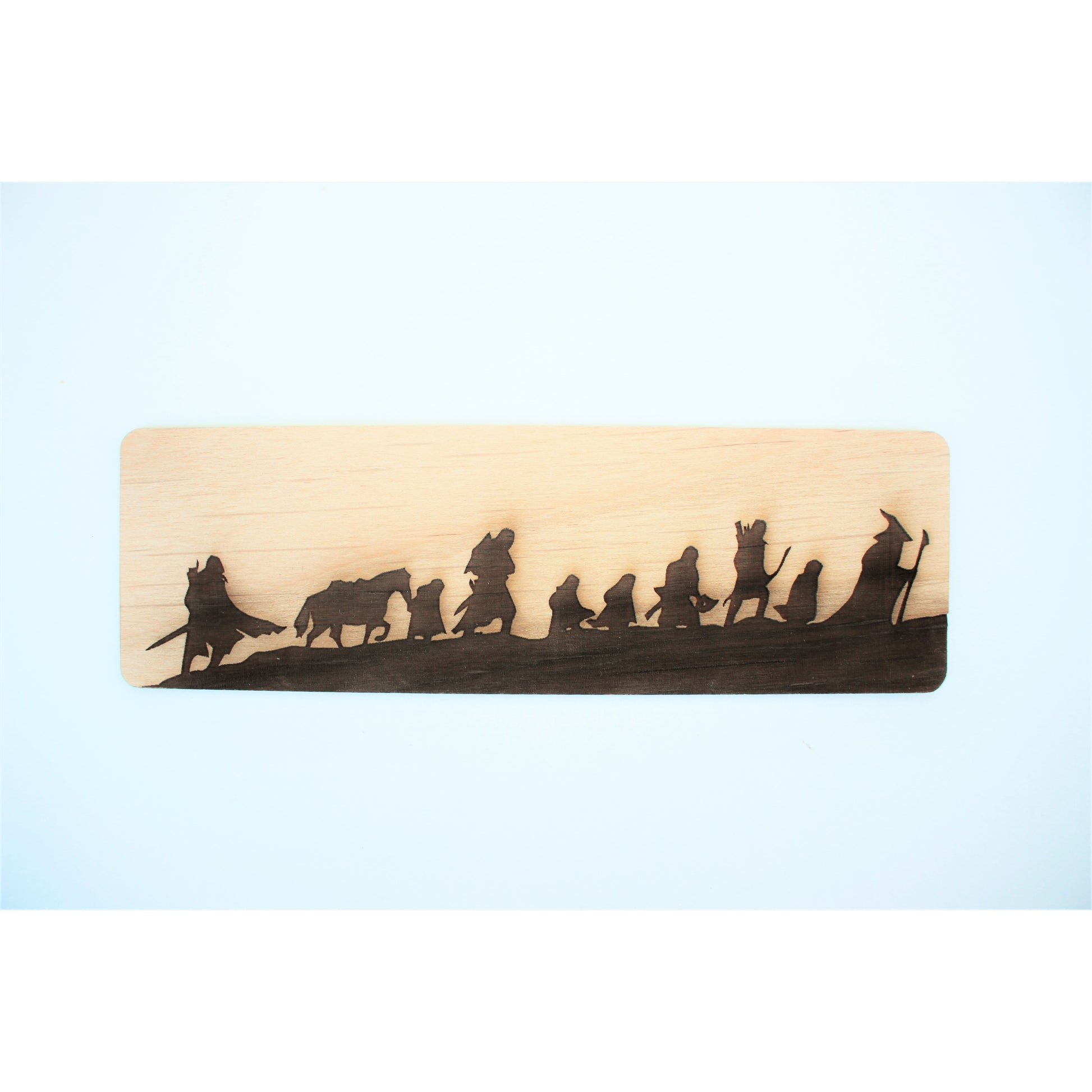 Tolkien Fellowship Wooden Bookmark - Light wooden bookmark featuring a dark silhouette of Tolkien's Fellowship characters in a line.