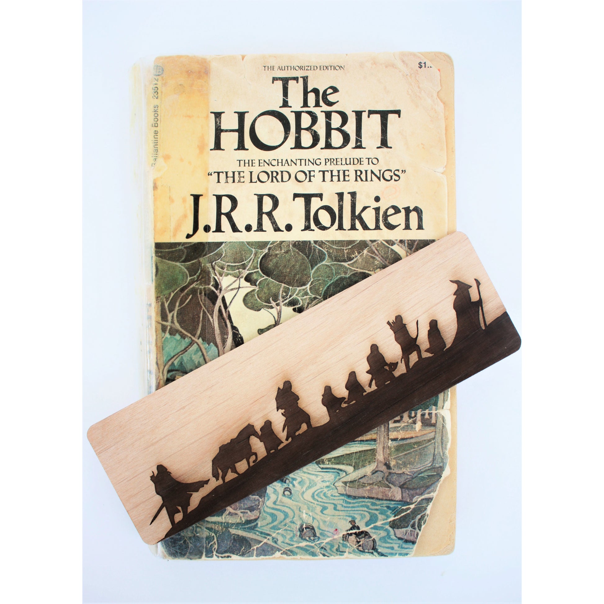 Tolkien Fellowship Wooden Bookmark - Wooden bookmark with dark silhouette of the Tolkien Fellowship walking, light wood grain background.