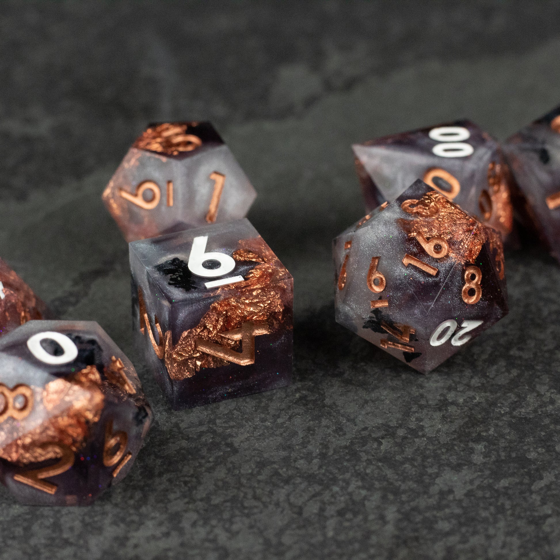 Lich King Dice Set - Black and metallic copper sharp-edged polyhedral dice set with white numbering, fantasy style.
