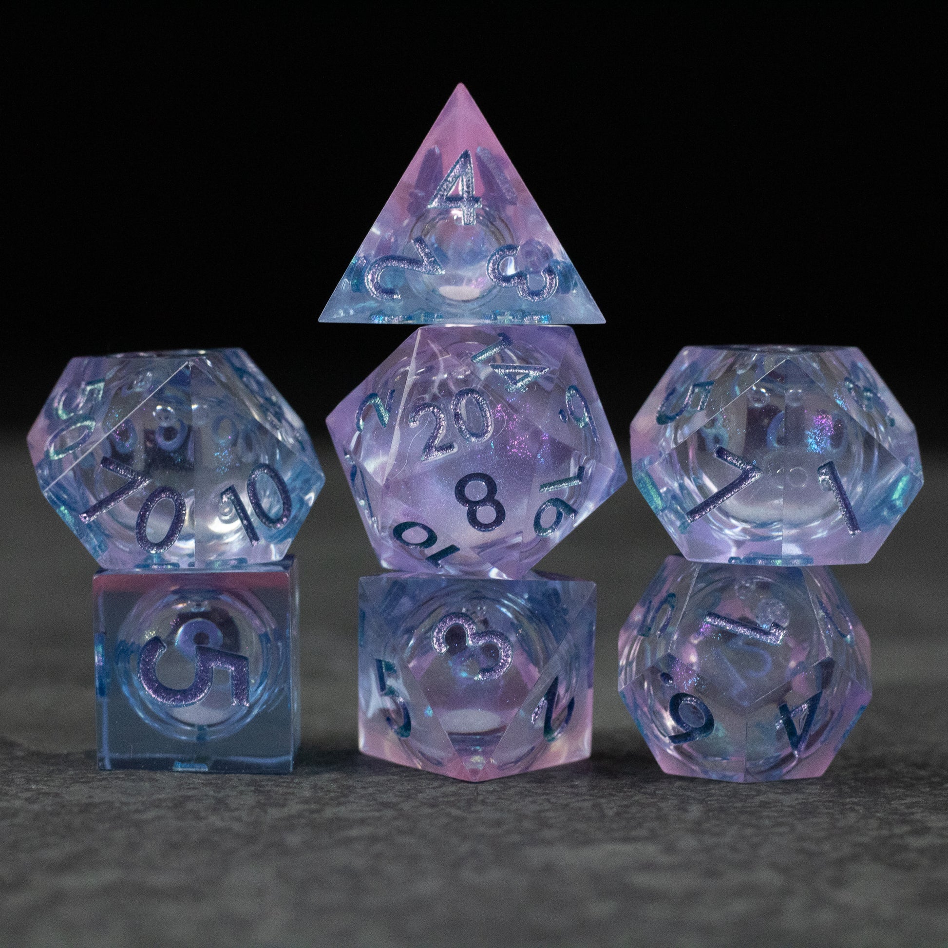 Fae Magic - Liquid Core Dice Set - Translucent purple and blue liquid core polyhedral dice set with black numbering, including d4, d6, d8, d10, d12, and d20.