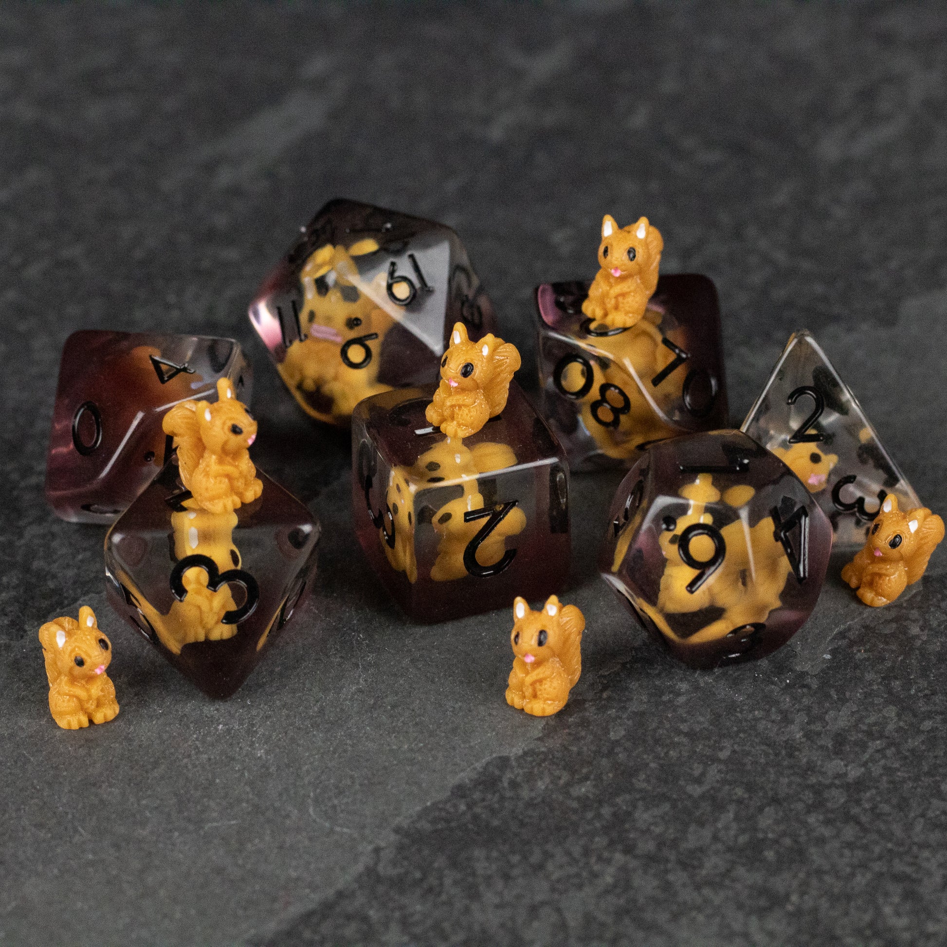 Squirrel Dice Set - Translucent brown polyhedral dice set with black numbers and small detailed yellow squirrel figurines attached and scattered .