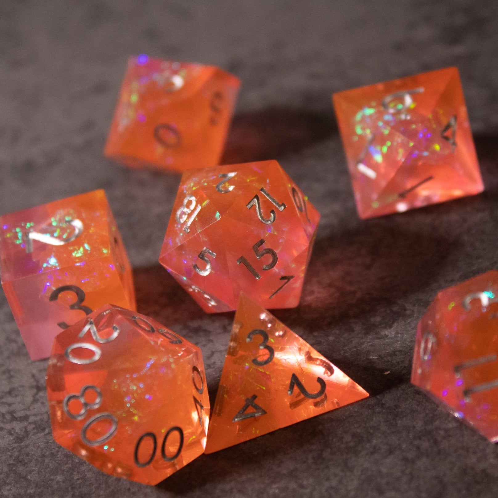 Heart Fire - Opalescent Sharp Edge Dice Set - Opalescent orange sharp-edged polyhedral dice set with iridescent flakes and white numbering.