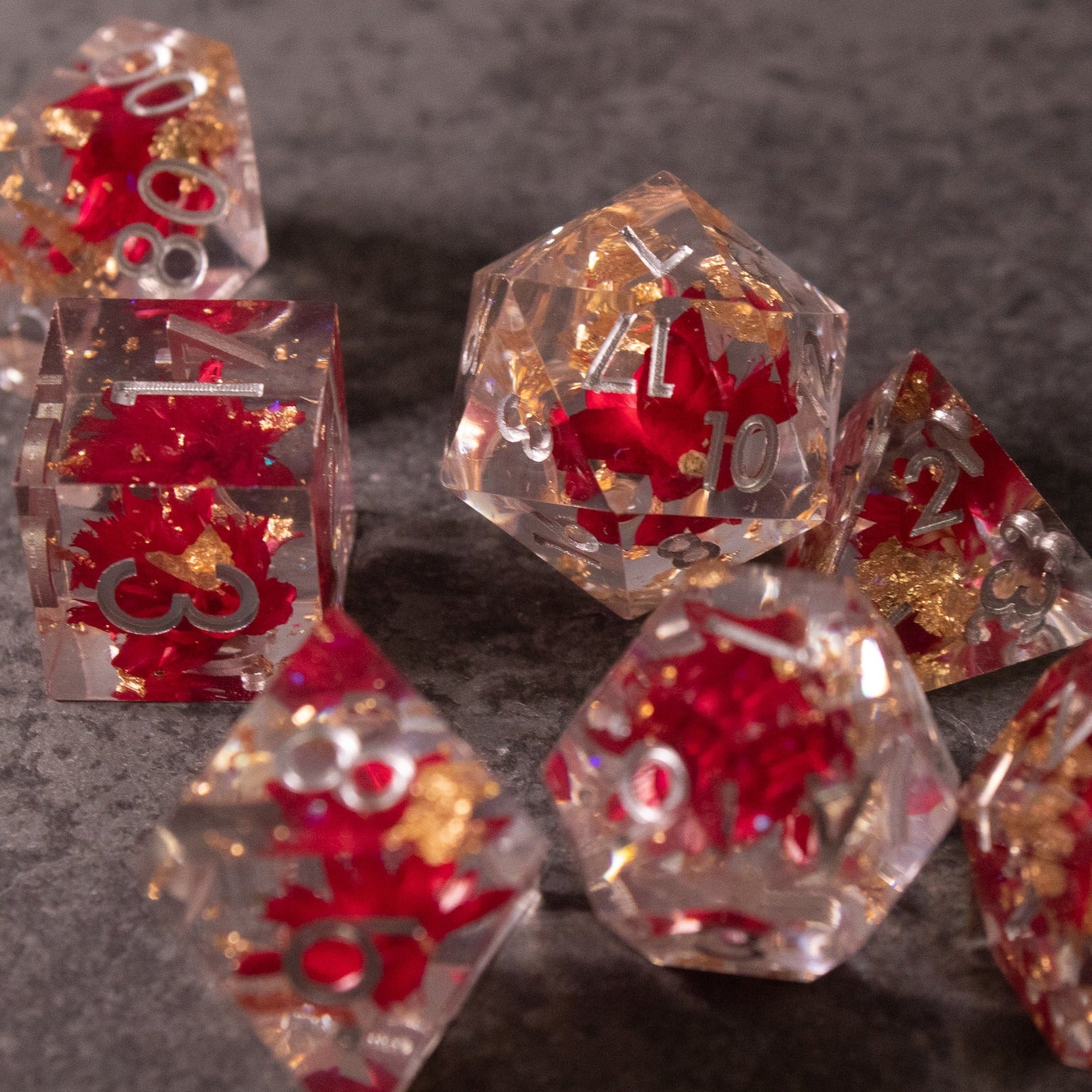 Red Lotus Flower Dice Set - Clear sharp-edged dice set with red lotus flower designs and gold numbering.